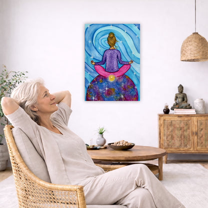Canvas of a woman meditating with her root chakra glowing. This is a print of the original hand-painted watercolor by Brazilian artist Thaís Suizo for the LET'S MEDITATE SERIES of mediation guides.  The poster is in the center of the living room wall. To the left a woman is relaxing in her chair with her hands behind her head. There is a small coffee table beside her with a bowl of walnuts, incense and a small green plant. On the right side of the room is a cabinet with a Buddha statue, books and an urn.