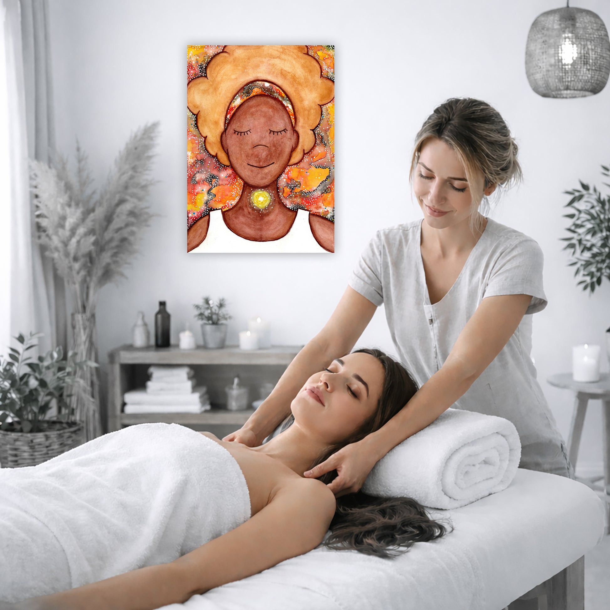 Woman's throat chakra energy glowing canvas. This is a print of the original hand-painted watercolor by Brazilian artist Thaís Suizo from the LET'S MEDITATE SERIES of mediation guides.  The poster is on the wall of the office of a massage therapist. The therapist is giving her female client a massage. The client is lying face up on a massage table wearing a white towel. To the left is a window, floor plant and large vase of dry flora. A shelf is underneath the poster with candles burning.  