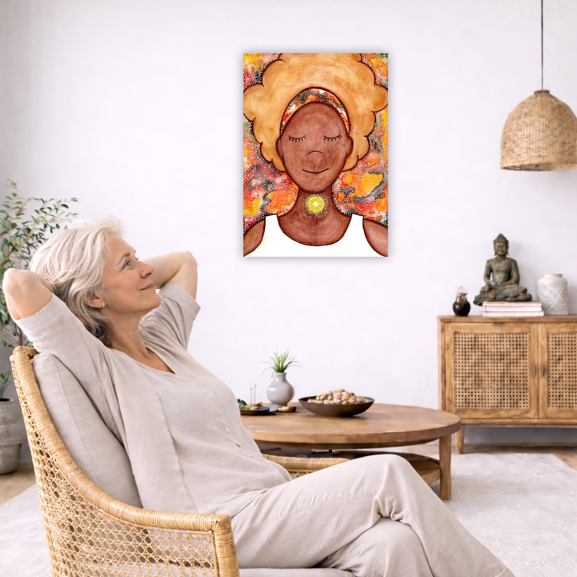 Woman's throat chakra energy glowing canvas. This is a print of the original hand-painted watercolor by Brazilian artist Thaís Suizo from the LET'S MEDITATE SERIES of mediation guides.  The poster is in the center of the living room wall. To the left a woman is relaxing in her chair with her hands behind her head. There is a small coffee table beside her with a bowl of walnuts, incense and a small green plant. On the right side of the room is a cabinet with a Buddha statue, books and an urn on it. To the le