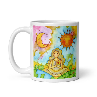Woman in meditation with sun and moon cosmic design on mug. This illustration is on both sides of the mug. In this image the handle of the mug is on the left side.