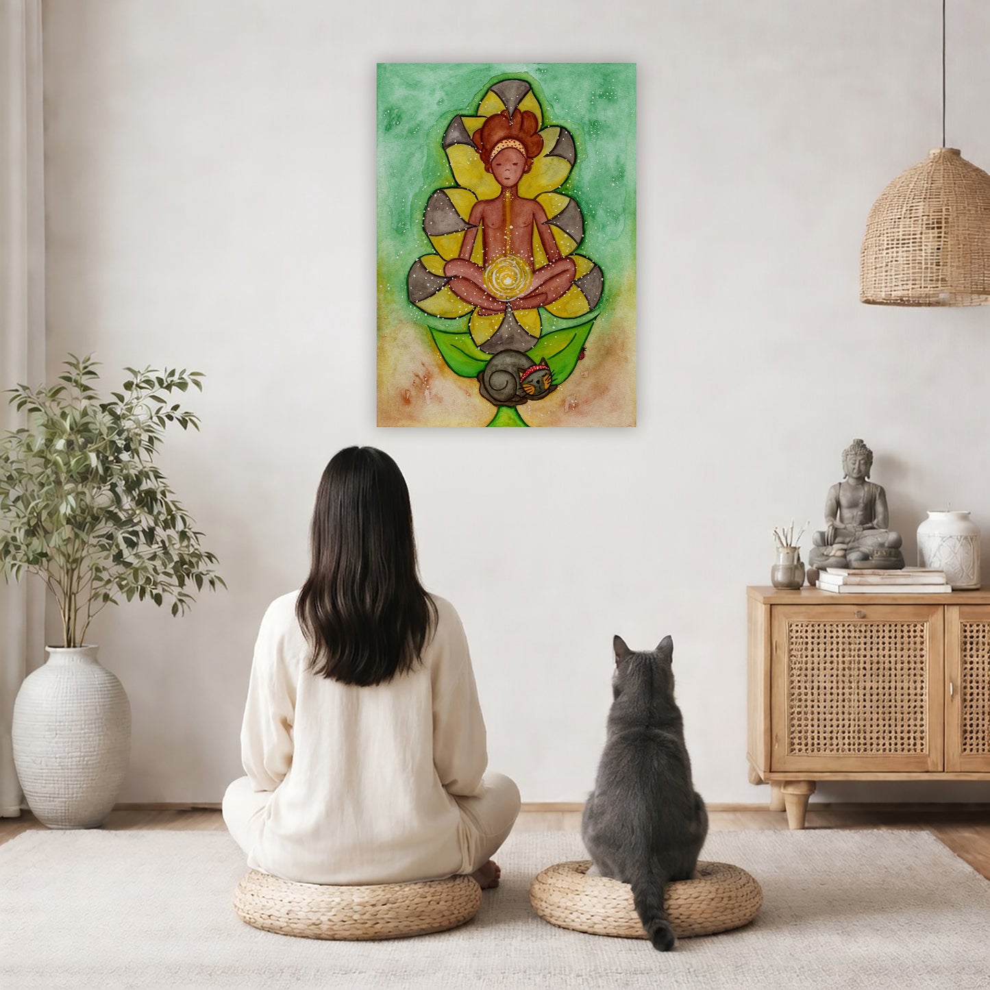 Canvas of a woman's sacral chakra glowing and the energy around her. This is a print of the original hand-painted watercolor by Brazilian artist Thaís Suizo for the LET'S MEDITATE SERIES of mediation guides.  The poster is in the center of the living room wall. A woman and a cat are staring up at the poster. There is a potted plant on the left side and a cabinet with a Buddha statue, books and incense on the right side.
 