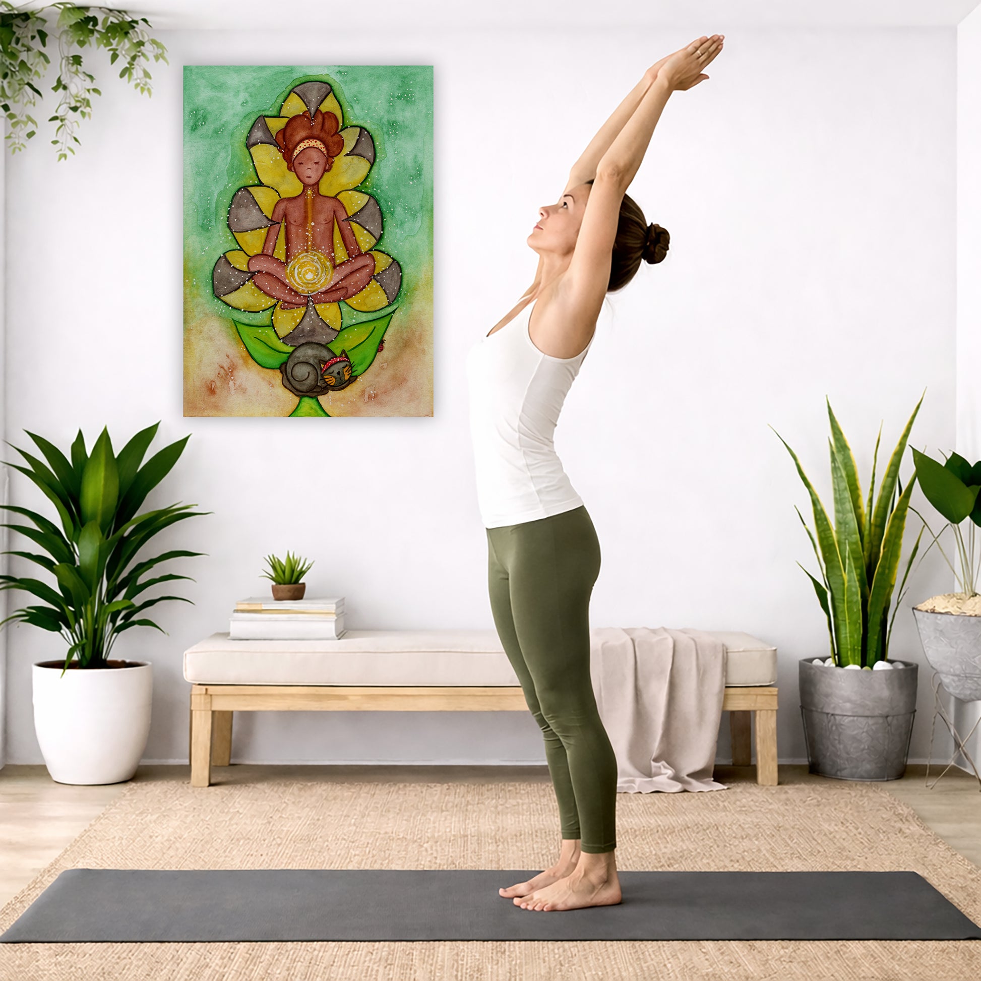 Canvas of a woman's sacral chakra glowing and the energy around her. This is a print of the original hand-painted watercolor by Brazilian artist Thaís Suizo for the LET'S MEDITATE SERIES of mediation guides.  The poster is in the center of the living room wall. A woman is doing a sun salutation on her yoga mat. There is a coffee table below the poster with burning candles, incense, a Buddha statue and a big piece of driftwood.

