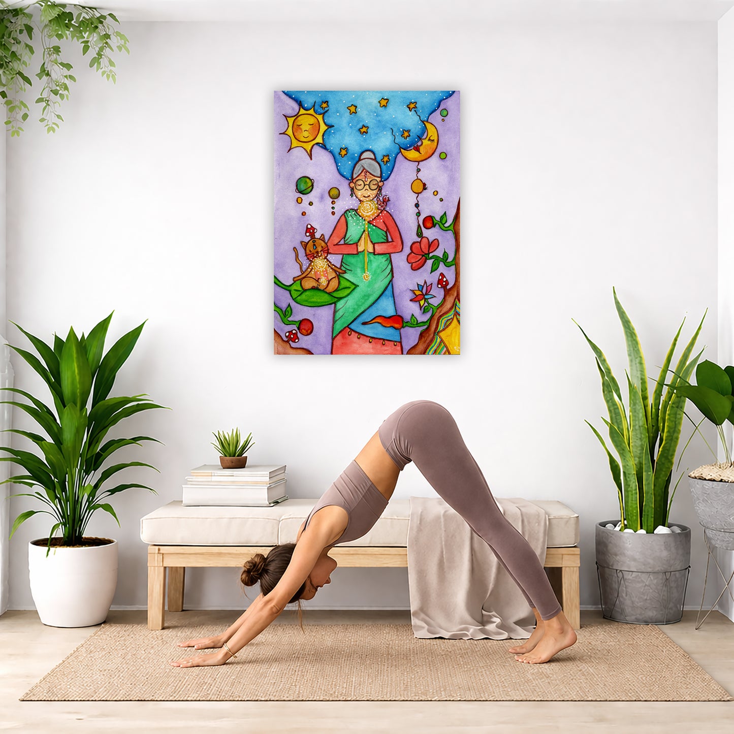 Throat chakra canvas print of a woman and her cat meditating under the sun and the moon. The poster is in the center of the living room wall. Below the poster a woman is doing the yoga posture downward facing dog on a yoga mat. 