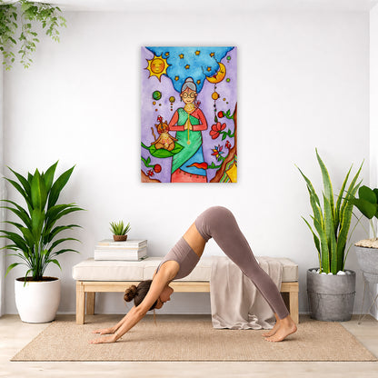 Throat chakra canvas print of a woman and her cat meditating under the sun and the moon. The poster is in the center of the living room wall. Below the poster a woman is doing the yoga posture downward facing dog on a yoga mat. 