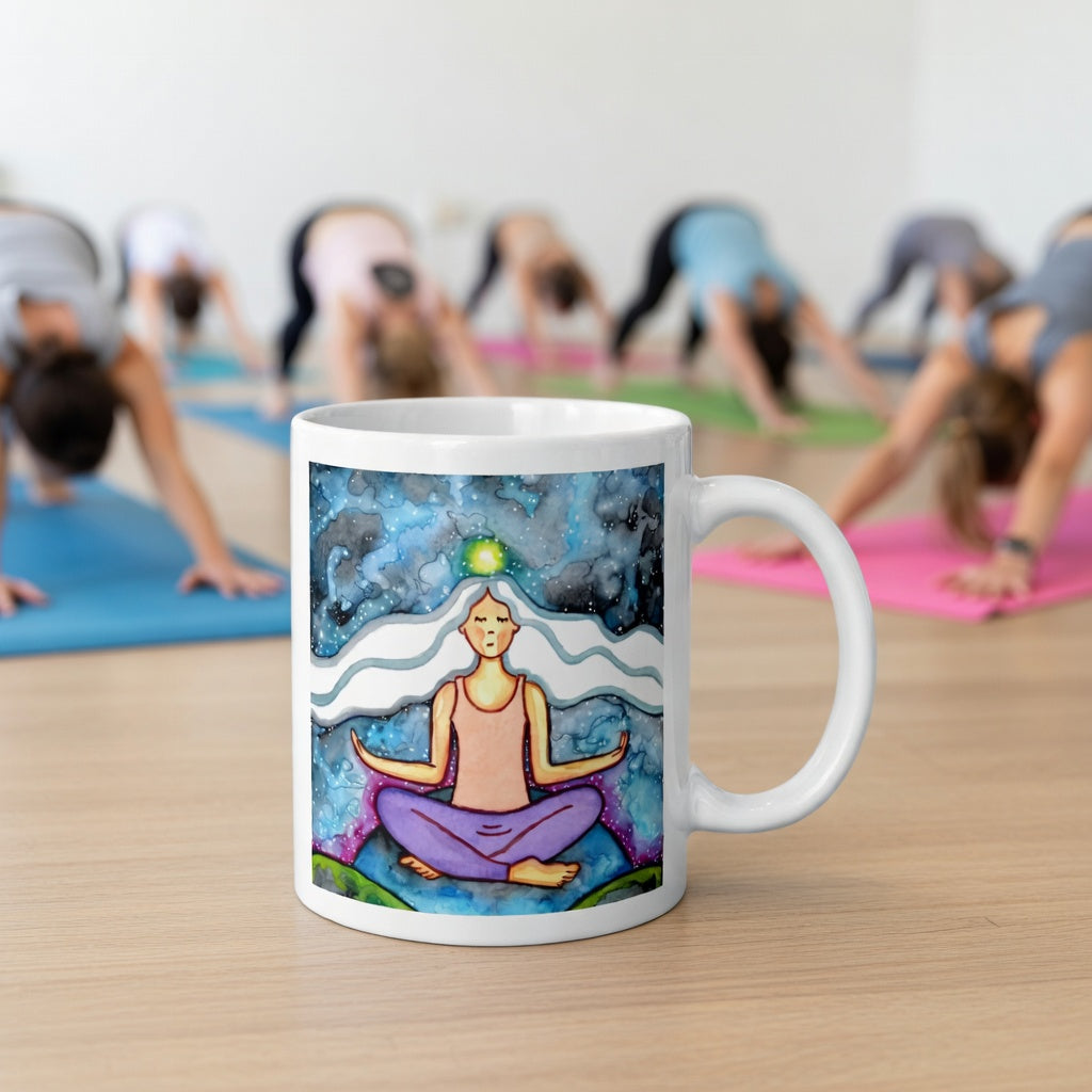 Meditating figure with glowing crown chakra at top of head, symbolizing higher consciousness and spiritual connection, chakra artwork featured on a mindfulness mug.  The mug is in front of a yoga class doing the downward facing dog posture.